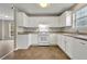 Kitchen with white cabinets, tile floor and gas range at 415 Gresham Dr, Stockbridge, GA 30281