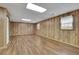 Finished basement with wood-paneled walls and vinyl flooring at 4179 White Rd, Snellville, GA 30039