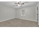 Spacious bedroom with ceiling fan and large window at 4179 White Rd, Snellville, GA 30039