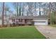 Ranch home with a carport and a grassy lawn at 4179 White Rd, Snellville, GA 30039