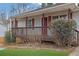 House exterior featuring a wooden deck and red front door at 4179 White Rd, Snellville, GA 30039