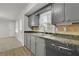 Gray kitchen with granite countertops and stainless steel dishwasher at 4179 White Rd, Snellville, GA 30039