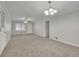 Open living room with neutral decor and carpet flooring at 4179 White Rd, Snellville, GA 30039