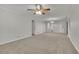 Living room with grey walls and carpet, plus a ceiling fan at 4179 White Rd, Snellville, GA 30039