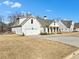 White two-story home with attached garage and large yard at 43 Harmony Woods Dr, Dallas, GA 30157