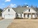 Craftsman style home with white siding, gray roof, and a two-car garage at 43 Harmony Woods Dr, Dallas, GA 30157