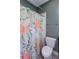 Small bathroom with shower, toilet and floral curtain at 1559 Walker Ave, College Park, GA 30337