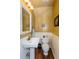 Small bathroom with pedestal sink, toilet, and decorative accents at 1559 Walker Ave, College Park, GA 30337