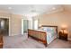 King-size bed in a well-lit bedroom with access to hallway at 1559 Walker Ave, College Park, GA 30337