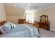 Spacious bedroom with large bed, dresser, and ceiling fan at 1559 Walker Ave, College Park, GA 30337