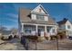 Two-story craftsman home with gray siding, brick accents, and a charming front porch at 1559 Walker Ave, College Park, GA 30337