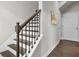 Staircase with dark wood railing and neutral walls at 1716 Prelude, Marietta, GA 30067