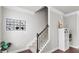 Bright stairwell with iron spindles, carpeted stairs and decorative shelving unit at 1716 Prelude, Marietta, GA 30067