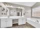 Double vanity bathroom with large mirror and tile floor at 1855 Charleston Oak Cir, Lawrenceville, GA 30043