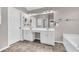 Double vanity bathroom with large mirror and tile floor at 1855 Charleston Oak Cir, Lawrenceville, GA 30043