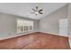 Bedroom with hardwood floors, large window, and ceiling fan at 1855 Charleston Oak Cir, Lawrenceville, GA 30043