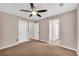 Spacious bedroom with ceiling fan and neutral carpeting at 1855 Charleston Oak Cir, Lawrenceville, GA 30043