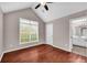 Hardwood floor bedroom with large window and ensuite bath at 1855 Charleston Oak Cir, Lawrenceville, GA 30043