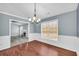 Bright dining room features hardwood floors and a chandelier at 1855 Charleston Oak Cir, Lawrenceville, GA 30043