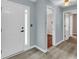 Modern entryway with white door and gray walls, vinyl flooring at 1855 Charleston Oak Cir, Lawrenceville, GA 30043