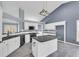 Modern kitchen with white cabinets, granite island, and stainless steel appliances at 1855 Charleston Oak Cir, Lawrenceville, GA 30043