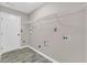 Bright laundry room with built-in shelving and tile floor at 1855 Charleston Oak Cir, Lawrenceville, GA 30043