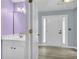 Powder room with white vanity and purple walls at 1855 Charleston Oak Cir, Lawrenceville, GA 30043