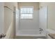 Cozy bathroom featuring a shower over tub combination with white tile surround at 1890 Old Concord Se Dr, Covington, GA 30016