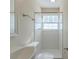 Bathroom featuring a shower with a silver shower head, surrounded by white tiles at 1890 Old Concord Se Dr, Covington, GA 30016