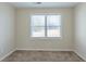 Small bedroom with window bringing in natural light and plush carpet flooring at 1890 Old Concord Se Dr, Covington, GA 30016