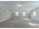 Spacious bonus room with carpet and natural light from two windows at 1890 Old Concord Se Dr, Covington, GA 30016