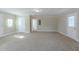 Large bonus room with carpet, multiple doors and natural light from windows at 1890 Old Concord Se Dr, Covington, GA 30016