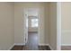 Hallway with neutral walls and modern flooring leading to a sunlit room at 1890 Old Concord Se Dr, Covington, GA 30016