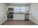 Well-lit kitchen with white cabinets, stainless steel appliances, and granite countertops at 1890 Old Concord Se Dr, Covington, GA 30016