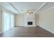 Bright living room with wood flooring, a white brick fireplace, and a ceiling fan at 1890 Old Concord Se Dr, Covington, GA 30016