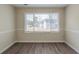 Bright living room features a large window with bright natural light and new hard wood floors at 1890 Old Concord Se Dr, Covington, GA 30016