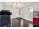 Formal dining room with hardwood floors, coffered ceiling, and chandelier at 5615 Cowles Cir, Suwanee, GA 30024