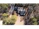 House nestled among trees, aerial view at 95 Twin Lakes Dr, Carrollton, GA 30116