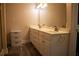 Bathroom with double vanity, patterned wallpaper and large mirror at 95 Twin Lakes Dr, Carrollton, GA 30116