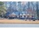 Brick house with a large yard and mature trees at 95 Twin Lakes Dr, Carrollton, GA 30116