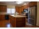 Kitchen with island, stainless steel appliances, and wood cabinets at 95 Twin Lakes Dr, Carrollton, GA 30116