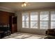 Living room with brick wall, window and wooden cabinet at 95 Twin Lakes Dr, Carrollton, GA 30116