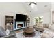 Living room with a fireplace, bookshelves, a ceiling fan, a skylight, and hardwood floors at 1164 Pine Grove Dr, Alpharetta, GA 30009