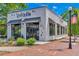 Trendy restaurant featuring a white brick facade, large windows, and outdoor seating, offering a stylish dining experience at 1164 Pine Grove Dr, Alpharetta, GA 30009