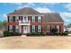 Brick two-story house with a large front yard and landscaping at 2108 Kendall Close Nw, Acworth, GA 30102