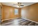 Simple bedroom with wood-look floors and ceiling fan at 3135 Reeves St, Smyrna, GA 30080