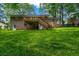The backyard features a wooden deck and stairs, surrounded by lush greenery at 6467 Joanna St, Lithia Springs, GA 30122