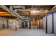 Unfinished basement featuring exposed wood ceiling, support beams, and concrete flooring at 6467 Joanna St, Lithia Springs, GA 30122