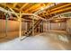Unfinished basement featuring exposed wood ceiling, support beams, and stairs at 6467 Joanna St, Lithia Springs, GA 30122