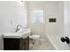 Updated bathroom featuring a soaking tub and modern vanity at 6467 Joanna St, Lithia Springs, GA 30122